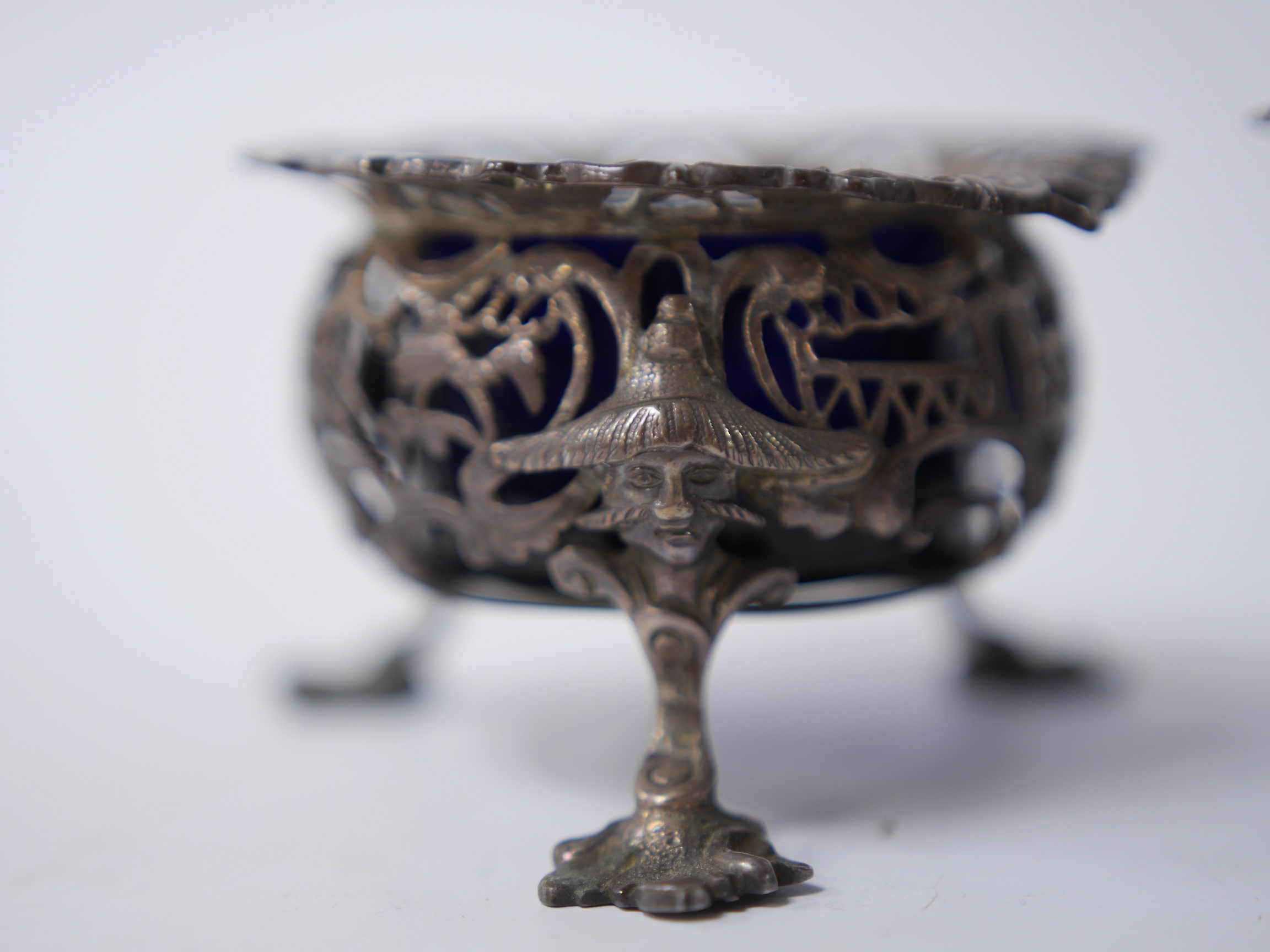 A pair of early Victorian pierced silver circular salts, with mask knees and scroll pad feet, John Wellby, London, 1841, diameter 77mm. Condition - fair